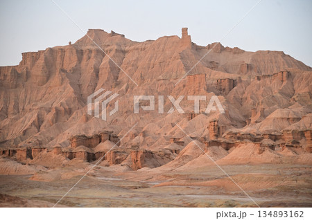 Kizil Red Stone Forest Scenic Area in Xinjiang , China is the strangely shaped red rock forests were carved by wind and sand over millions of years, giving them the appearance of abandoned cities. 134893162