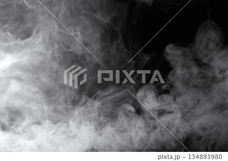 Abstract white smoke and fog drifting on dark black background with ample copy space, atmospheric texture for overlays and design Abstract white smoke and fog drifting on dark black background with ample copy space, atmospheric texture for overlays and design 134893980