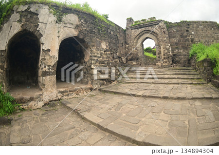 Classic arched entrance at Daulatabad Fort is an ancient fort located in Maharashtra, India. Originally named Deogiri, it is a fort built from natural rocks and is very strong. 134894304