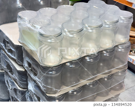 Stacked empty glass jars in bulk packaging Stacked empty glass jars in bulk packaging 134894520