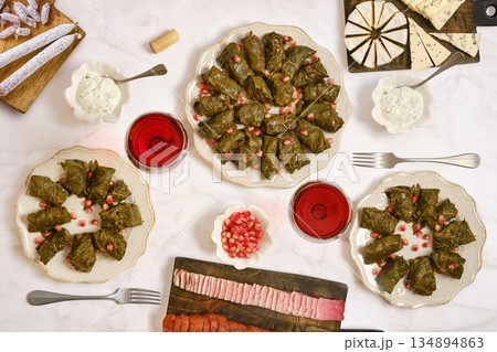 Delicious table set with stuffed grape leaves and other dishes for a gathering 134894863
