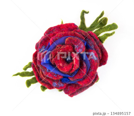 Brooch felted wool in the form of a flower on a white background Brooch felted wool in the form of a flower on a white background 134895157