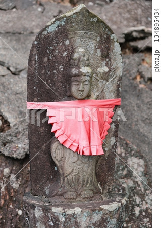 Ancient Stone Buddha With Red Ribbon Ancient Stone Buddha With Red Ribbon 134895434