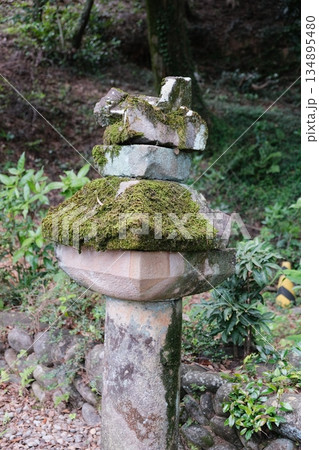 Ancient Stone Pillar Covered In Green Moss 134895480