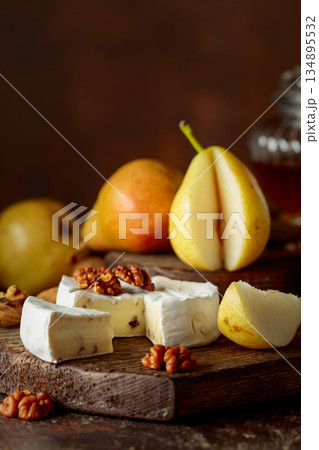 Camembert cheese with pears, walnuts, and honey. 134895532