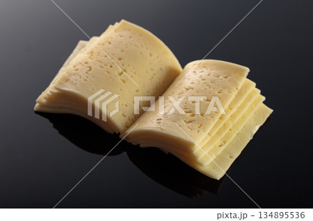 Cheese slices folded like an open book. 134895536