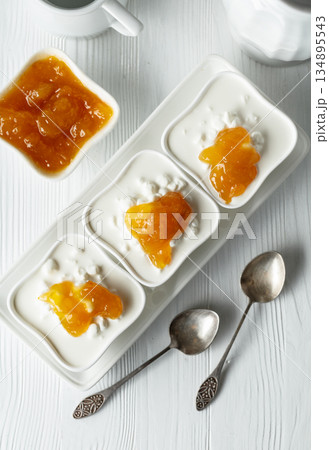 Cottage cheese with cream and yellow jam. 134895543