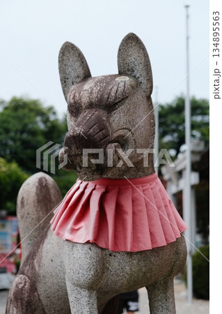 Stone Lion Guardian With Red Sash Stone Lion Guardian With Red Sash 134895563
