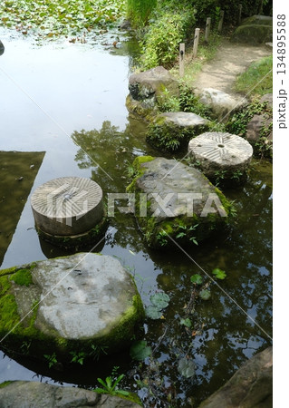 Ancient Stone Mill Wheels Mossy Garden 134895588