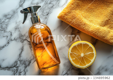 Shiny. Minimalist flat lay cleaning concept. Single spray bottle, microfiber cloth and lemon on a white marble background. 134895962