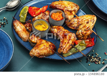 Grilled chicken wings kebab skewers and roasted vegetables Grilled chicken wings kebab skewers and roasted vegetables 134896180