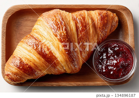 Breakfast board. Breakfast on a tray with a plate of jam and croissant on a white background. Hotel breakfast styles. Top view. 134896187