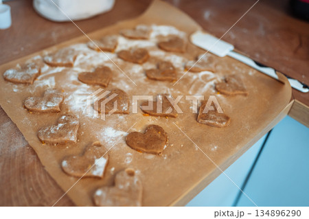 making heart-shaped gingerbread cookies making heart-shaped gingerbread cookies 134896290
