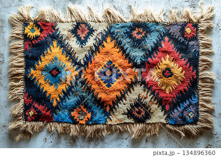 Handwoven rug texture with geometric print on a white background. Top view. Handwoven rug texture with geometric print on a white background. Top view. 134896360