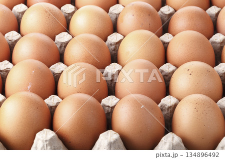 Brown chicken eggs in a carton isolated on a white background Brown chicken eggs in a carton isolated on a white background 134896492