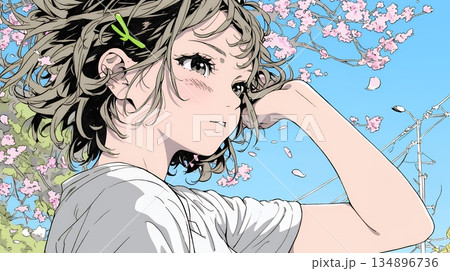 満開の桜の下、春風に乱れた髪を整える若い女性