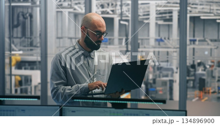 Engineer Tracking Production Process With Handheld Device 134896900