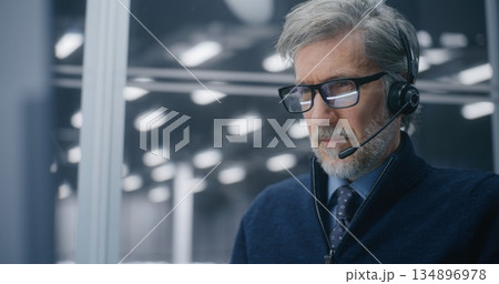 Professional in Call Center Setup, Answering Critical Technical Issues With Headset in Server Hall 134896978