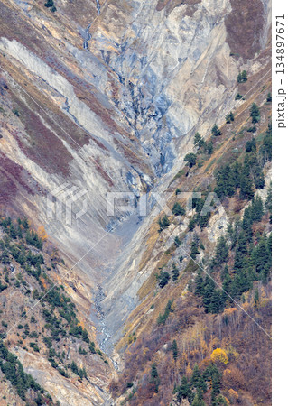 A mountain range with a deep valley in the middle A mountain range with a deep valley in the middle 134897671