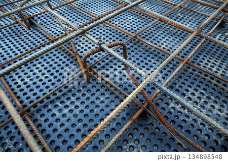 The construction of a concrete foundation using reinforcing steel prepared at the construction site The construction of a concrete foundation using reinforcing steel prepared at the construction site 134898548