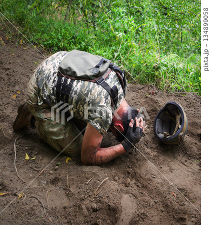 Sad soldier cry on the ground 134899058