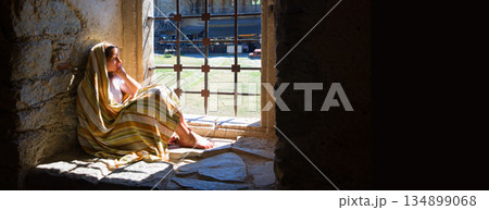 Lone girl sitting in the castle Lone girl sitting in the castle 134899068