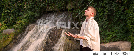 Young guy at old waterfall 134899069