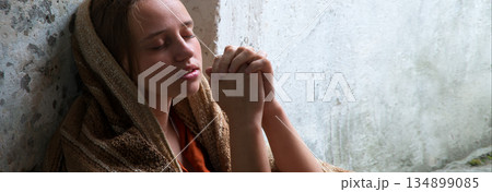 Poor young girl prayint to God Poor young girl prayint to God 134899085