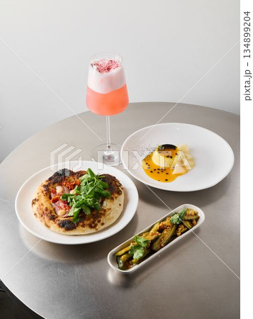 Sophisticated plating featuring seared protein and delicate garnishes 134899204