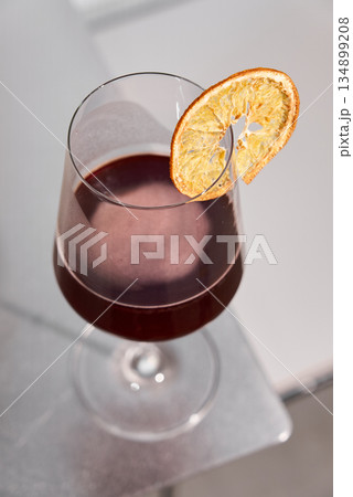 Relaxed Afterhours Cocktail Atmosphere, Elegant Drink With Orange Garnish Under Soft Lighting Ambiance 134899208