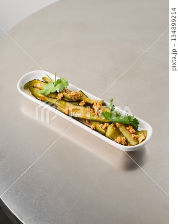Elegant herb roasted potato ribbons served in modern setting with garnish 134899214