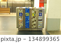 Indoor recycling station with separate bins for plastic cans and paper. Multi compartment waste sorting bin in modern building. Multi-compartment recycling bins are located inside public buildings. 134899365