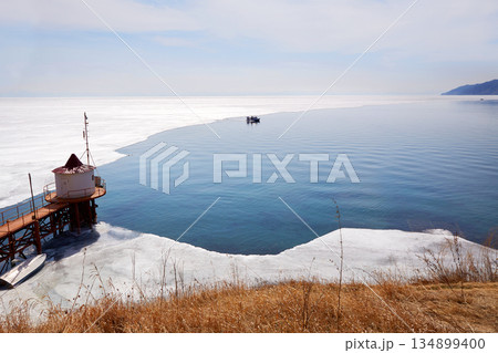 Lake Baikal in spring. A hovercraft transports tourists Lake Baikal in spring. A hovercraft transports tourists 134899400
