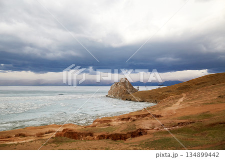 Beautiful view of Cape Burkhan or Shamanka Rock on Olkhon Island on a cloudy spring day. 134899442