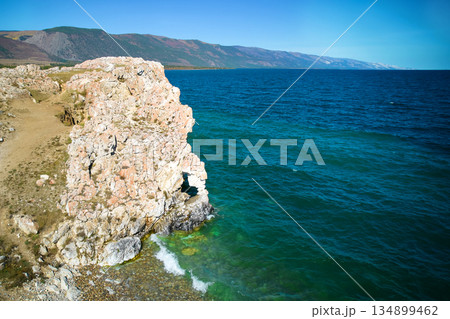 Lake Baikal. Turquoise water color. A rock with a hole in the shape of a heart on Cape Tsagan-Khushun Lake Baikal. Turquoise water color. A rock with a hole in the shape of a heart on Cape Tsagan-Khushun 134899462