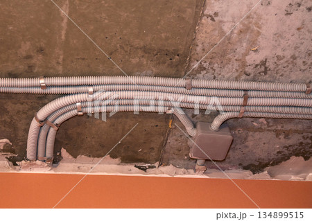Installation of electrical wiring on the ceiling. Installation of electrical wiring on the ceiling. 134899515