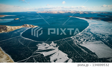 Lake Baikal in December. View of the freezing Muhur Bay from the air. Lake Baikal in December. View of the freezing Muhur Bay from the air. 134899532