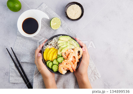 Poke bowl of shrimps, rice, avocado, cucumber, mango Poke bowl of shrimps, rice, avocado, cucumber, mango 134899536
