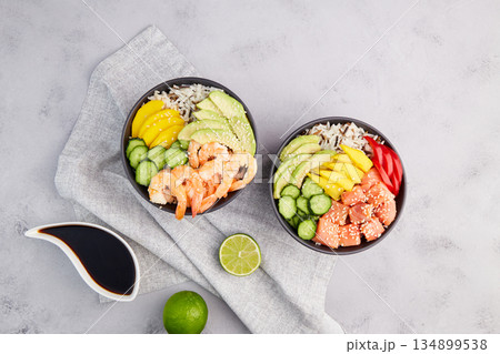 Poke bowl with salmon,shrimps, rice, avocado, cucumber, mango, pepper 134899538