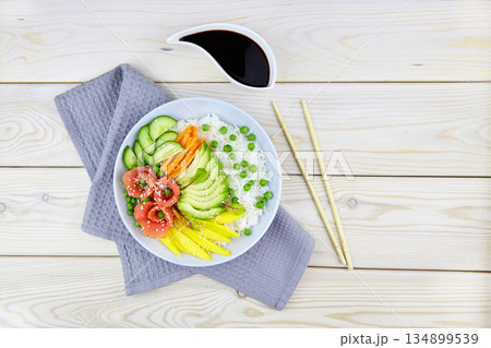 Poke bowl with salmon, rice, avocado, cucumber, mango, micro green Poke bowl with salmon, rice, avocado, cucumber, mango, micro green 134899539