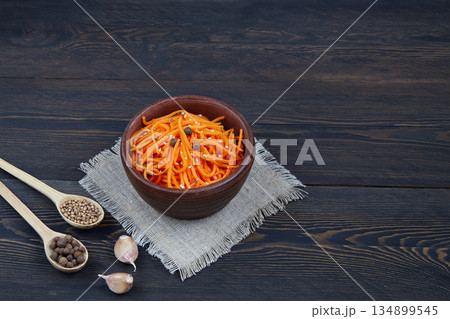 Traditional Korean spicy carrot salad with garlic and coriander. 134899545