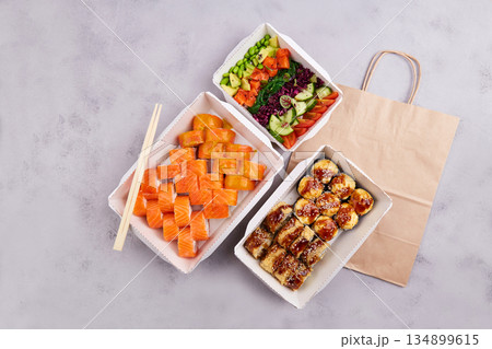 Sushi set and poke bowl with trout, avocado and vegetables. 134899615
