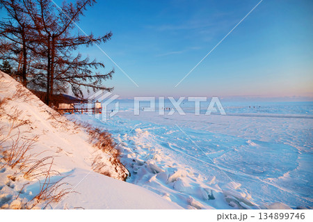 Beautiful landscape of frozen Lake Baikal at sunset in winter. Beautiful landscape of frozen Lake Baikal at sunset in winter. 134899746