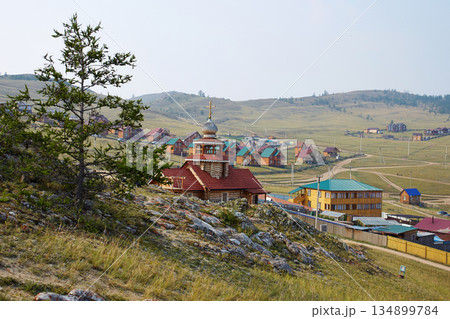 Summer landscape. View of wooden houses, tourist hotels, wooden church Summer landscape. View of wooden houses, tourist hotels, wooden church 134899784