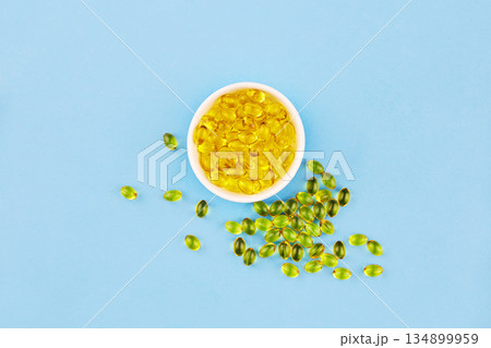 Yellow capsules with Vitamin D3. Healthy and medical concept, sunshine vitamin. 134899959