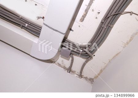 Installation of electrical wiring and ventilation on the ceiling. Installation of electrical wiring and ventilation on the ceiling. 134899966