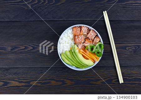 Hawaiian salmon fish poke bowl with rice, avocado, cucumber, carrot Hawaiian salmon fish poke bowl with rice, avocado, cucumber, carrot 134900103
