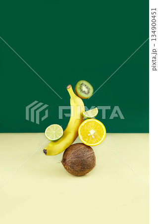 Balancing fruits: coconut, orange, banana, kiwi and lime . 134900451