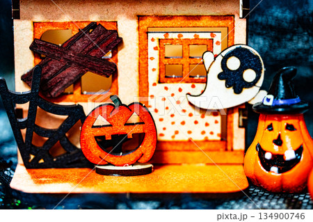 Cardboard house and Pumpkin carved into spooky demon face for halloween 134900746
