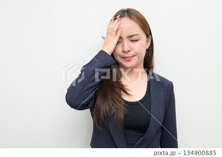 Portrait of stressed young Asian businesswoman against white background 134900885